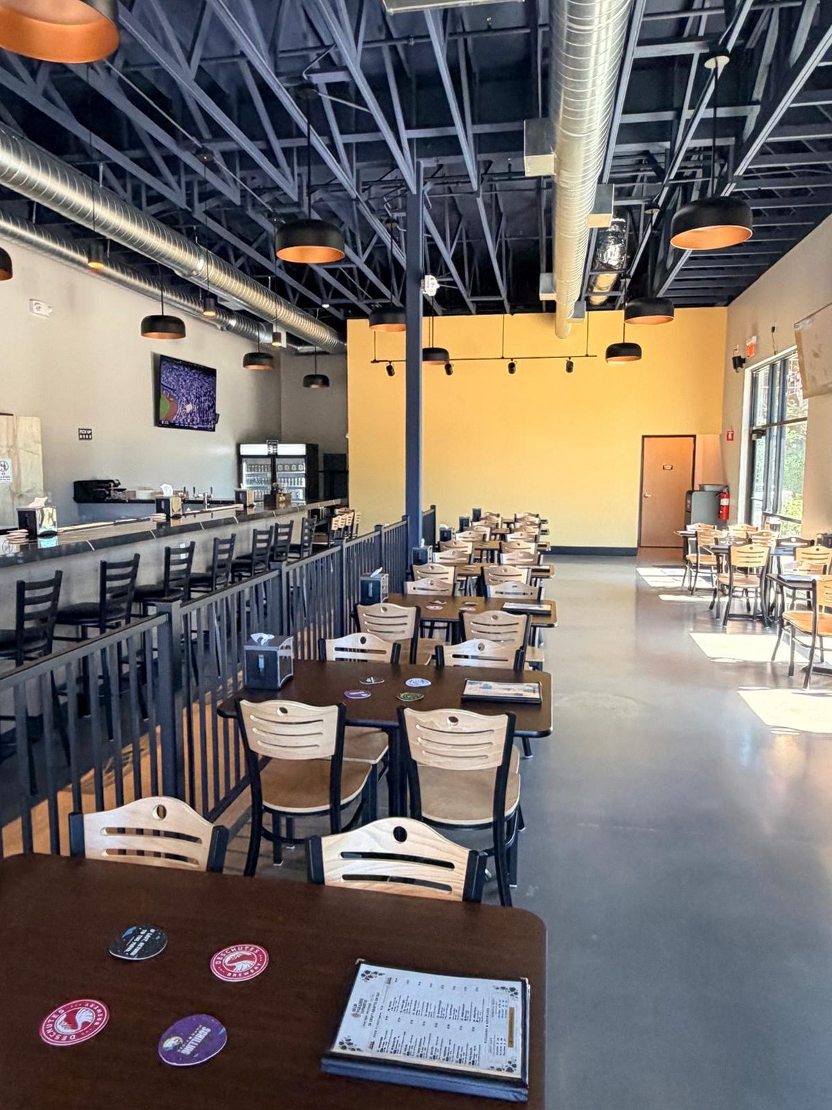 Friends sharing a table inside the taproom